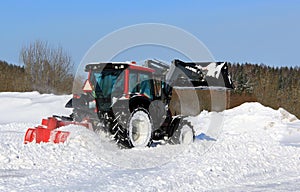 Tractor Plowing Snow on a Yard