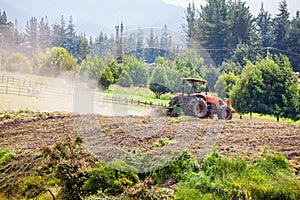 Tractor plowing to sow yellow potato