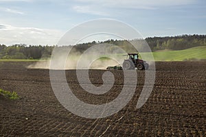 Tractor Plowing. Tractor plowing a  field and creating a cloud of dust.