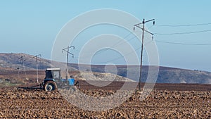 Tractor plows a farm field photo