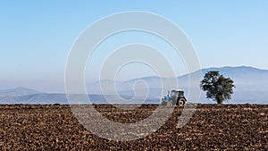 Tractor plows a farm field