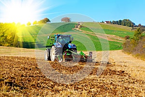 Tractor plows a field photo