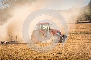 Tractor plows a field - agriculture and agronomy concept