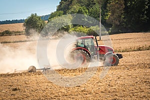 Tractor plows a field - agriculture and agronomy concept