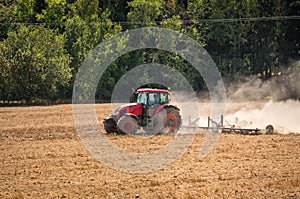 Tractor plows a field - agriculture and agronomy concept