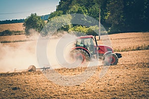 Tractor plows a field - agriculture and agronomy concept