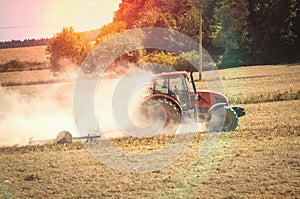 Tractor plows a field - agriculture and agronomy concept