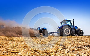 The tractor plows the field, cultivates the soil for sowing grain. The concept of agriculture