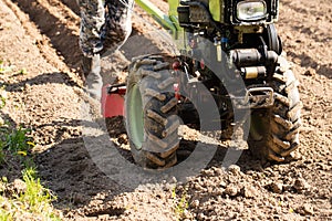 Tractor Plows Land On Agricultural Field In Spring Close Up