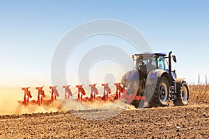 The tractor prepares the ground for sowing and cultivation. Agronomy, the concept of farming. Agricultural machinery for fields,