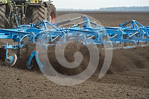 Tractor preparing land with seedbed cultivator as part of pre se