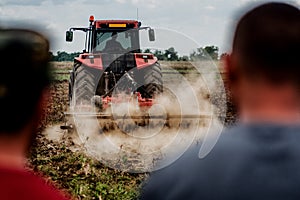 Tractor preparing land for sowing out in the field