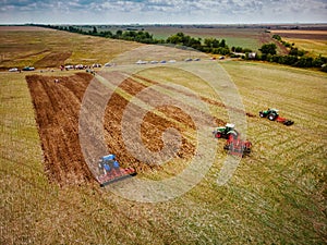 Tractor preparing land for sowing out in the field