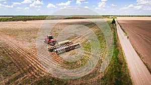 Tractor preparing land for sowing sixteen rows aerial, concept of cultivation, sowing, plowing field, tractor and production autom