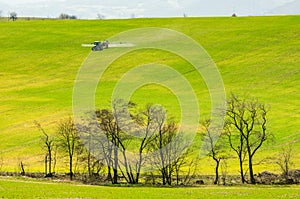 Tractor preparing spring agriculture field and using insecticide which help for the soil