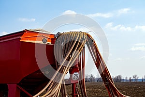 Tractor with seeder in the field in early spring
