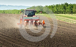 Tractor and seeder for sowing corn