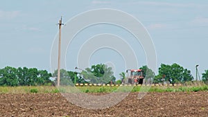 Tractor With Seeder Sowing Crops In The Field