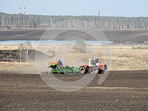 Tractor and seeder in the spring