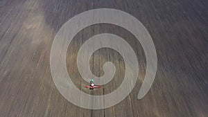 Tractor with the seeder working at the large field