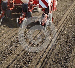 Tractor seeding crops at field.