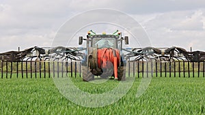 Tractor with a slurry spreader Dribble Bar in a field. UK