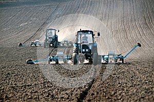 Tractor with sower on the field