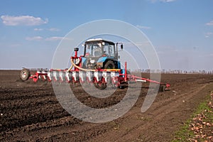 Tractor with sower on the field photo