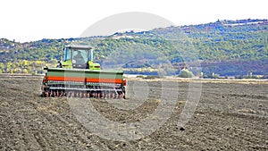 Tractor sowing and cultivating field