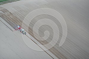 Tractor at sowing in the field photo