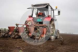Tractor sowing field in spring time