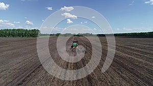 Tractor sows the field view from the air