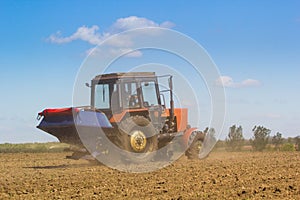 Tractor Spaying a field in the spring