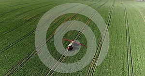 Tractor spray fertilize on field with chemicals in agriculture field.