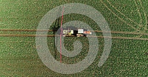 Tractor spray fertilize on field with chemicals in agriculture field.