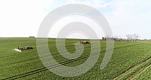 Tractor spray fertilize on field with chemicals in agriculture field.