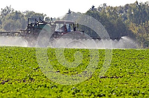 Tractor spray fertilize with insecticide herbicide chemicals in agriculture field