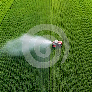 Tractor spray fertilizer on green field drone high angle agriculture background concept