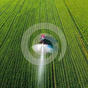 Tractor spray fertilizer on green field drone high angle agriculture background concept
