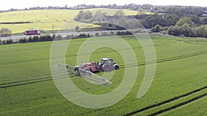 Tractor spraying a banned glyphosate herbicide on agricultural land