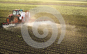 Tractor spraying corn field