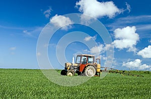 Tractor spraying green field