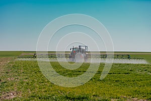 Tractor Spraying Herbicides on Field Agriculture