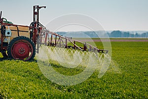 Tractor Spraying Herbicides on Field Agriculture