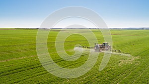 Tractor Spraying Herbicides on Field Agriculture photo