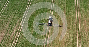 Tractor Spraying Pesticides on Crops at Agriculture Field