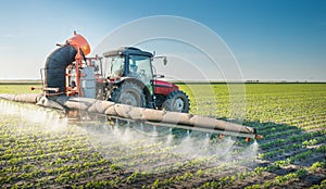 Tractor spraying pesticides photo