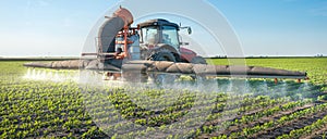 Tractor spraying pesticides photo