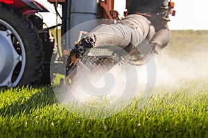 Tractor spraying pesticides wheat field