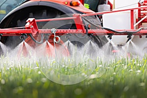 Tractor spraying pesticides wheat field